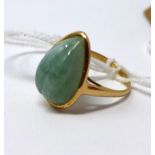 A 9ct yellow gold, pear-shaped carved green jade ring, Size N 1/2, 4g