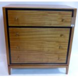 A Loughborough teak chest of four long drawers, the top drawer with fitted interior, raised on
