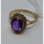 A 9ct yellow gold ring set with a large oval faceted natural amethyst of fine rich purple hue, Size: