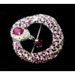 A sterling silver coiled snake brooch, pave-set with natural rubies and white sapphires