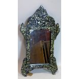 A Middle Eastern ebonised mirror with mother of pearl inlay, 75 x 44cm