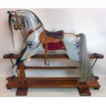 A 20th century carved and painted wooden rocking horse, H.125 W.153 D.27cm
