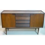 A mid 20th century teak sideboard, four drawers flanked by two cupboard doors, raised on tapered