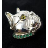 A sterling silver pendant/brooch in the form of a dog's head with an emerald studded collar