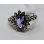 A 9ct white gold tanzanite and white sapphire cluster ring, centrally set with a large oval