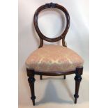 A Victorian walnut balloon back chair