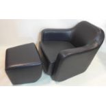 A black leather armchair and foot stool