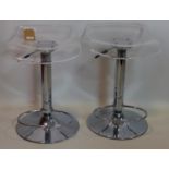 A pair of chrome and perspex stools