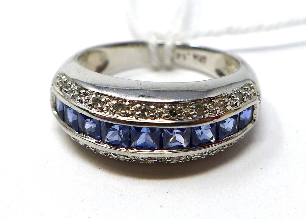 A 9ct white gold diamond and Ceylon sapphire ring, centrally set with a row of 9 princess-cut ceylon