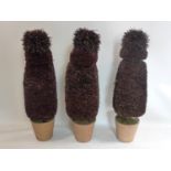 A set of three faux trees in pots, H.112cm