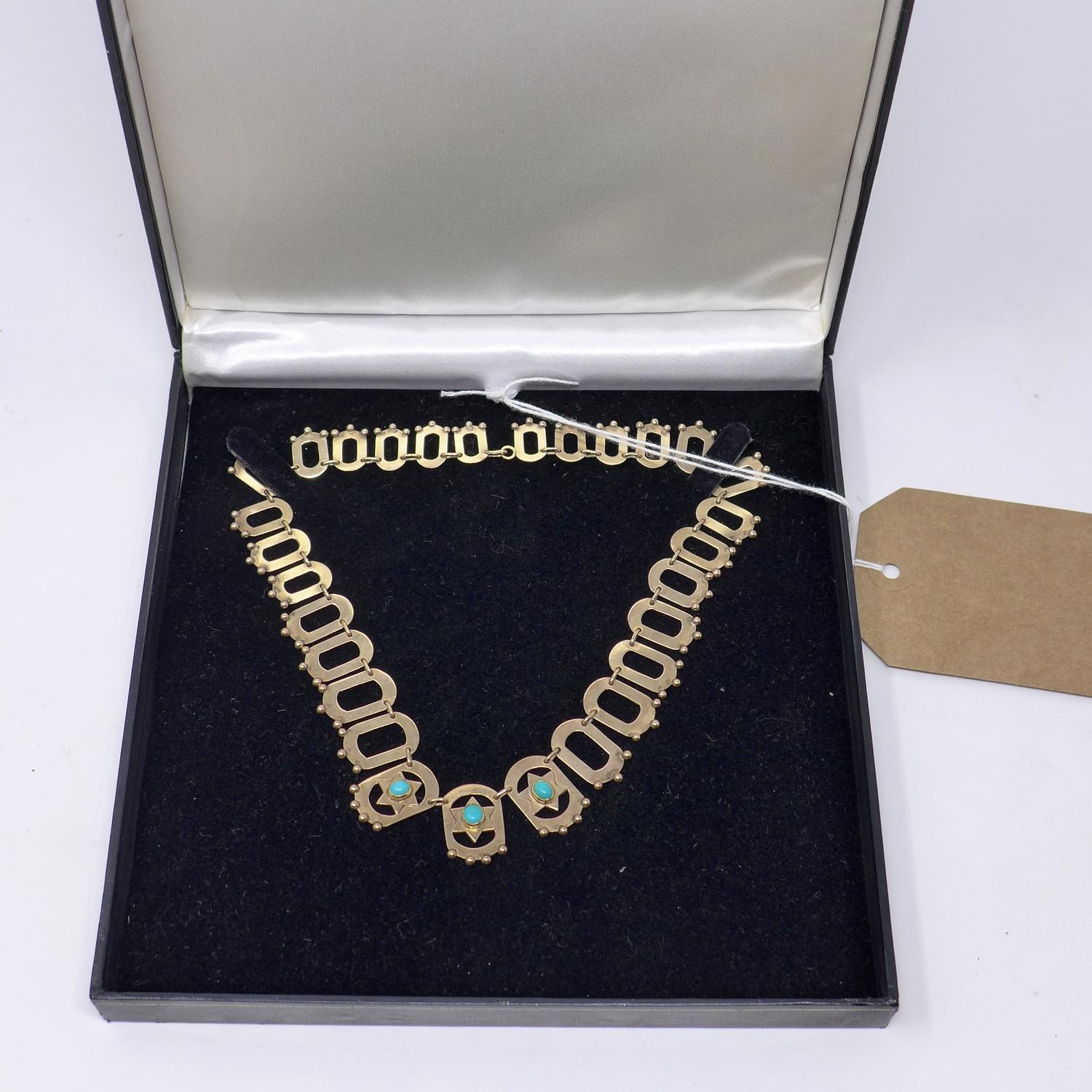 A 9ct yellow gold Judaic oval linked necklace centrally set with three turquoise cabochons within