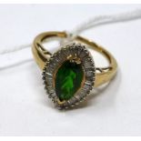 A 9ct yellow gold ring centrally set with a marquise-cut faceted deep green tourmaline framed by