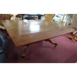 A William IV mahogany drop leaf dining table, with twin pillar supports, joined by stretcher, raised