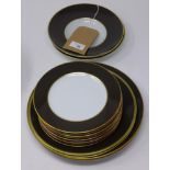 Legle Limgoes, bronze and gold rimmed porcelain collection: 2 large plates, 2 medium plates, 2