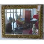 A gilt framed mirror with bevelled plate
