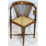 A mahogany corner chair with cane seat