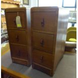 A pair of Art Deco walnut pedestal chests with Bakelite handles, H.73 W.28 D.51cm