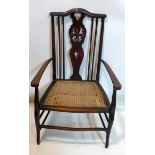 An Arts & Crafts mahogany chair with cane seat