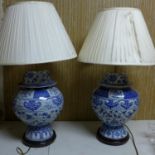 A pair of Chinese blue and white porcelain jars and covers, converted to lamps, H.46cm