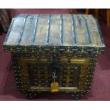 A 20th century Middle Eastern iron & brass bound teak dowry box on wheels, H.62 W.66 D.50cm