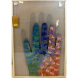 A Contemporary handicraft jigsaw art piece in the form of a hand, framed