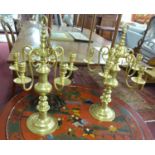 A pair of French brass candelabra, stamped 'Le Grand, Paris', five scrolling branches raised on
