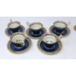 A set of five 19th century Royal Worcester porcelain cups and saucers, with 'Old Worcester Parrot'