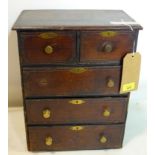 An oak apprentice piece chest of two short over three long drawers, brass handles (1 missing) and