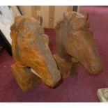Two cast iron horse heads on block bases, H.30cm (2)