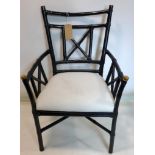 An ebonised bamboo design armchair, with brass caps