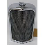 A 1950/60's chrome flask in the form of a Jaguar radiator, H.18 W.11 D.7cm