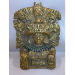 A gilt painted cast plaster plaque of a South American deity, H.44 W.32cm