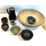 A collection of 20th century English studio pottery, some signed, together with a large wooden fruit