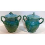 A pair of Persian cyan glazed pots and covers, with rope twist design handles, H.39cm (2)