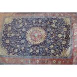 A North West Persian Sarouk carpet, double pendent medallion with repeating petal motifs on a