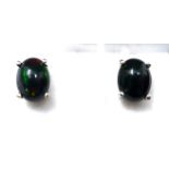 A boxed pair of sterling silver black Ethiopian opal cabochon stud earrings (flashes of blue,
