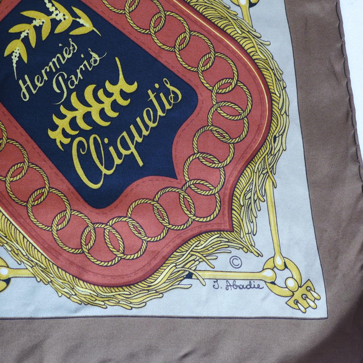 A vintage Hermes silk scarf in brown entitled 'Cliquetis', Designer: J. Abadie, 85 x 90cm approx - Image 2 of 2