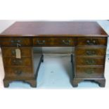 A Georgian style mahogany pedestal desk, with tooled leather top, raised on bracket feet, H.76 W.136