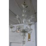 An early 20th century Venetian style three branch chandelier, with floral glass stem decoration,