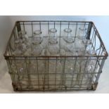 A collection of vintage glass milk bottles in vintage wire crate