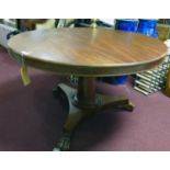 A Victorian mahogany breakfast table raised on paw feet and castors, H.75cm Diameter 128cm
