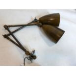 A pair of brass angle poise wall lights