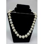 A string of pearls composed of thirty-two large, creamy-white cultured pearls with a 9ct white