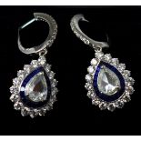 A boxed pair of 18ct white gold diamond and sapphire drop earrings, each earring centrally set