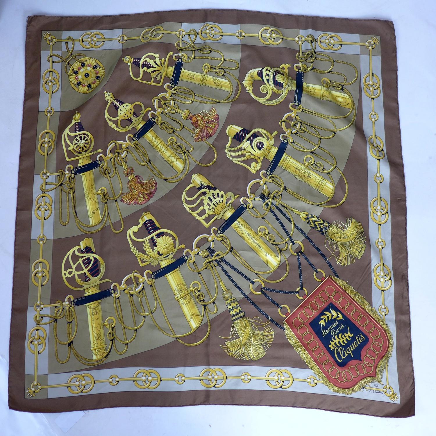 A vintage Hermes silk scarf in brown entitled 'Cliquetis', Designer: J. Abadie, 85 x 90cm approx