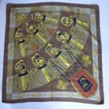 A vintage Hermes silk scarf in brown entitled 'Cliquetis', Designer: J. Abadie, 85 x 90cm approx