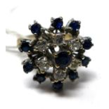 An 18ct white gold, diamond and sapphire cluster ring, English hallmarks, with six round brilliant