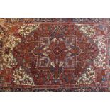 A North West Persian Heriz carpet, central diamond medallion with repeating geometric motifs on a