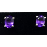 A boxed pair of sterling silver and oval faceted amethyst stud earrings, 1.2g