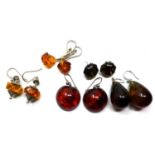 Five pairs of sterling silver earring to include four natural amber drop and stud examples and a